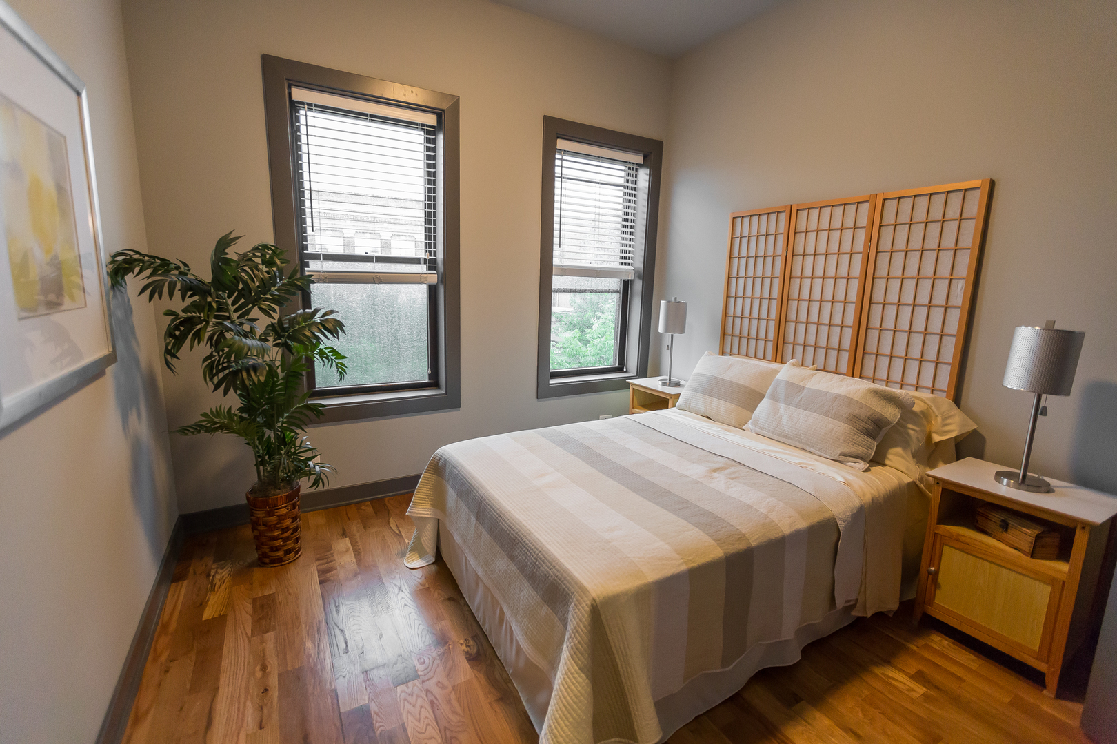Undisclosed Address Chicago, IL 60657 - Photo 7 of 13 a bedroom with a bed table closet and windows