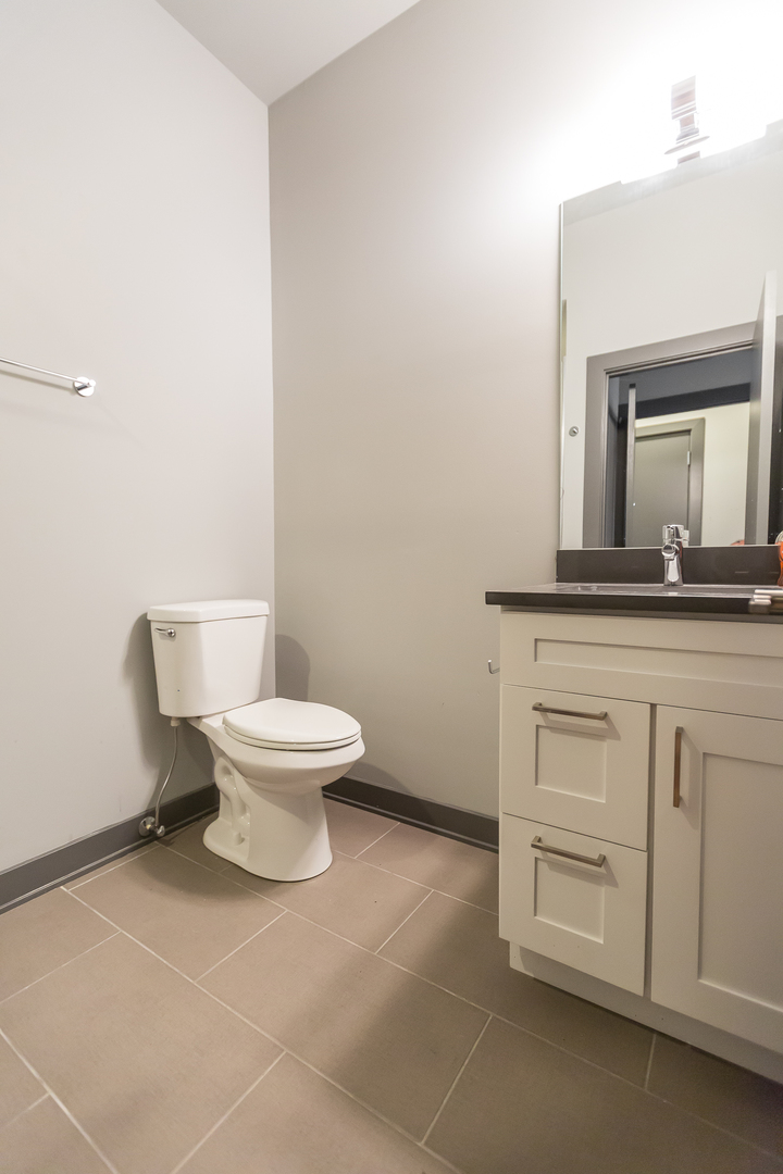Undisclosed Address Chicago, IL 60657 - Photo 10 of 13 a white toilet sitting next to a bathroom sink