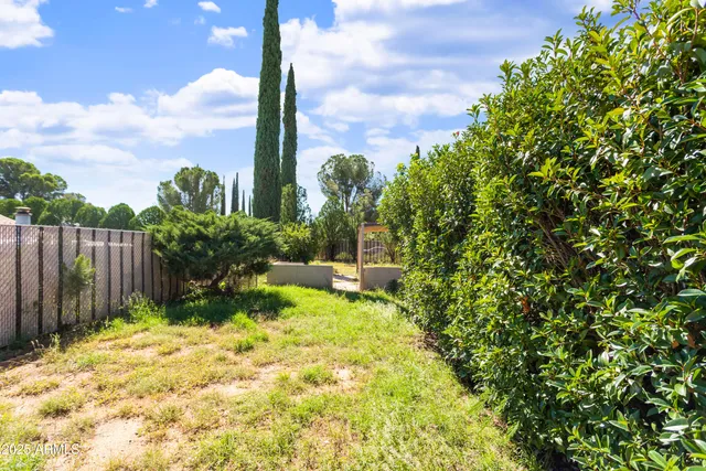 a backyard of a house with a table and chairs