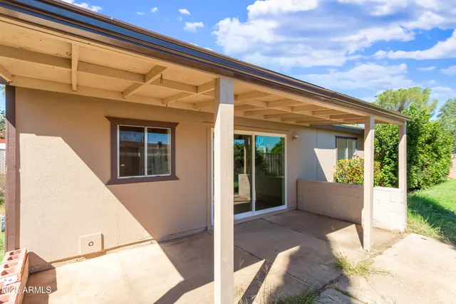 a view of a house with many windows and plants