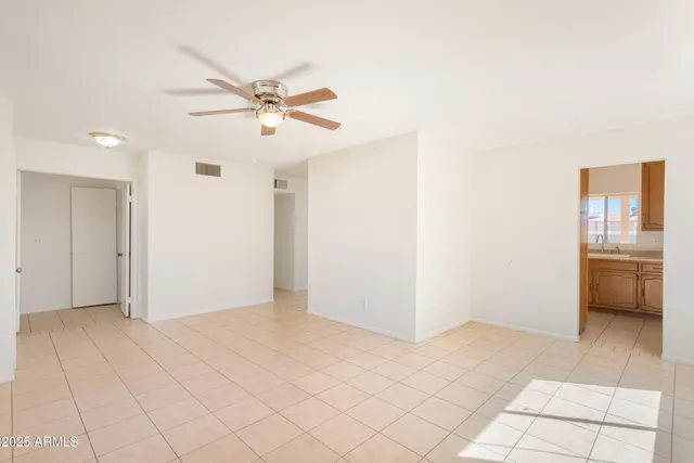 a view of a livingroom with a ceiling fan and window