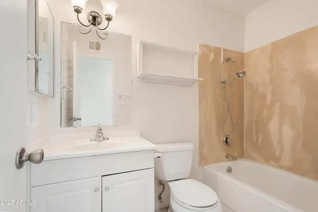 a bathroom with a sink toilet tub and shower
