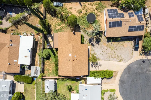 aerial view of a house with yard and swimming pool