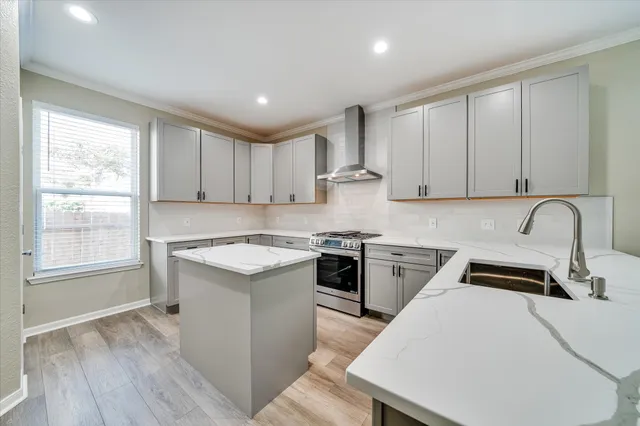 a kitchen with a stove a sink and a microwave