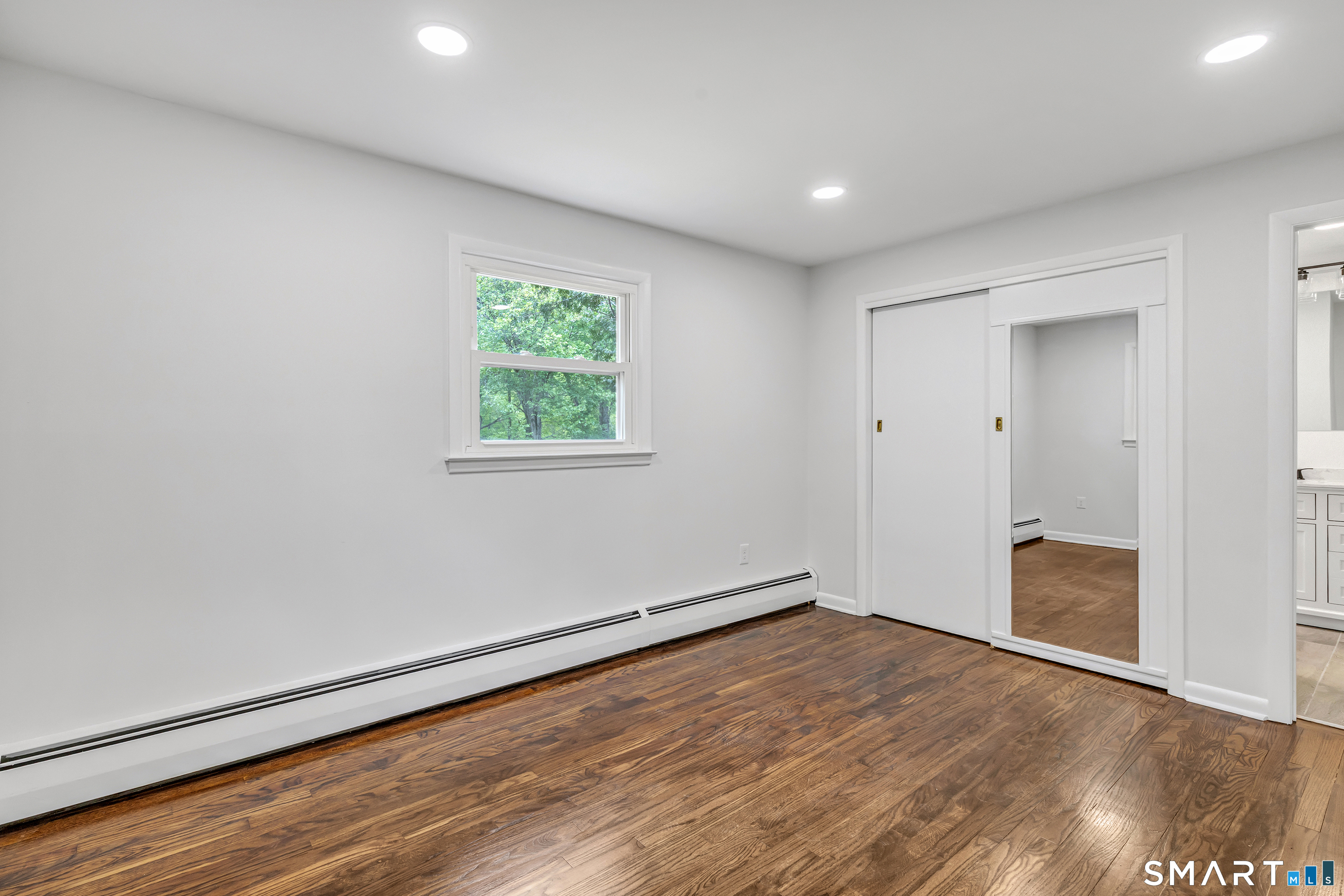 7 Longview Road Newtown, CT 06482 - Photo 26 of 40 an empty room with wooden floor and windows