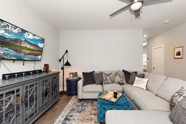 a living room with furniture and wooden floor