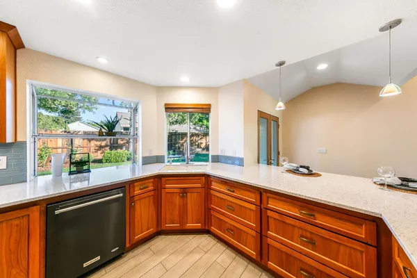 a kitchen with a sink and large windows