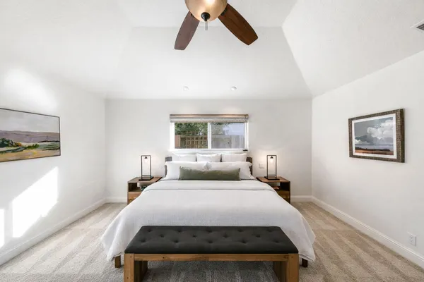 a bedroom with a bed and a window