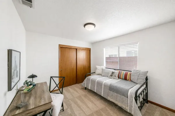 a bedroom with furniture and a window