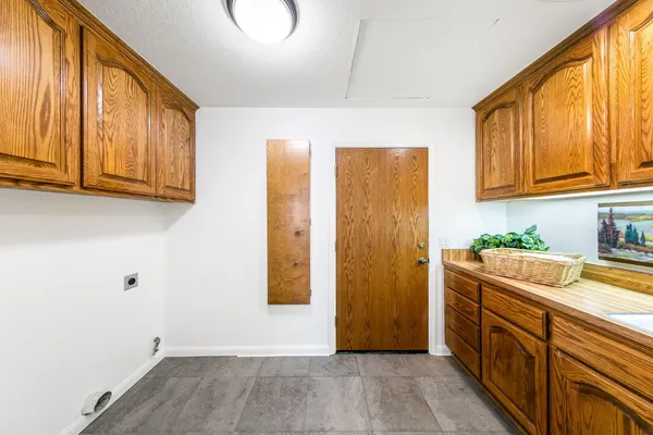a view of a kitchen with fridge and wooden floor