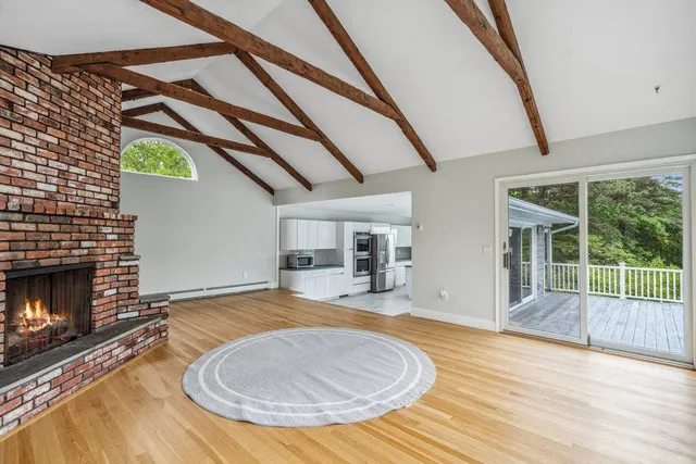 a living room with a fireplace furniture and a wooden floor