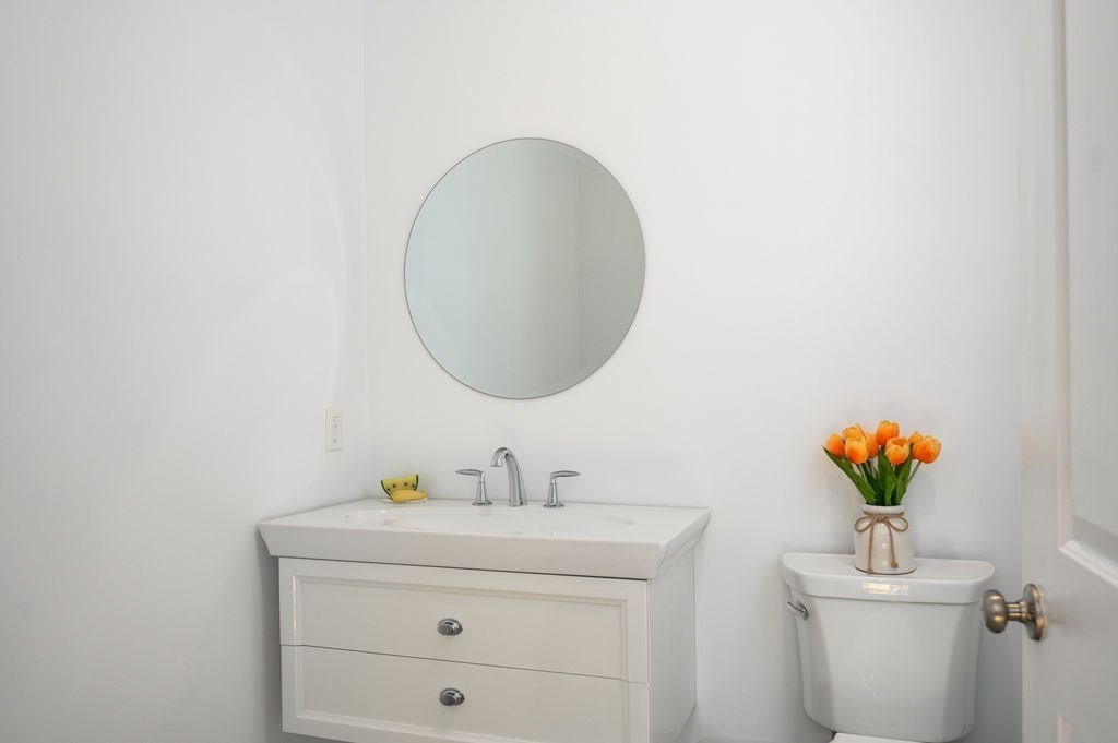196 Main Street, Unit 196 Groveland, MA 01834 - Photo 11 of 35 a bathroom with a sink mirror and toilet
