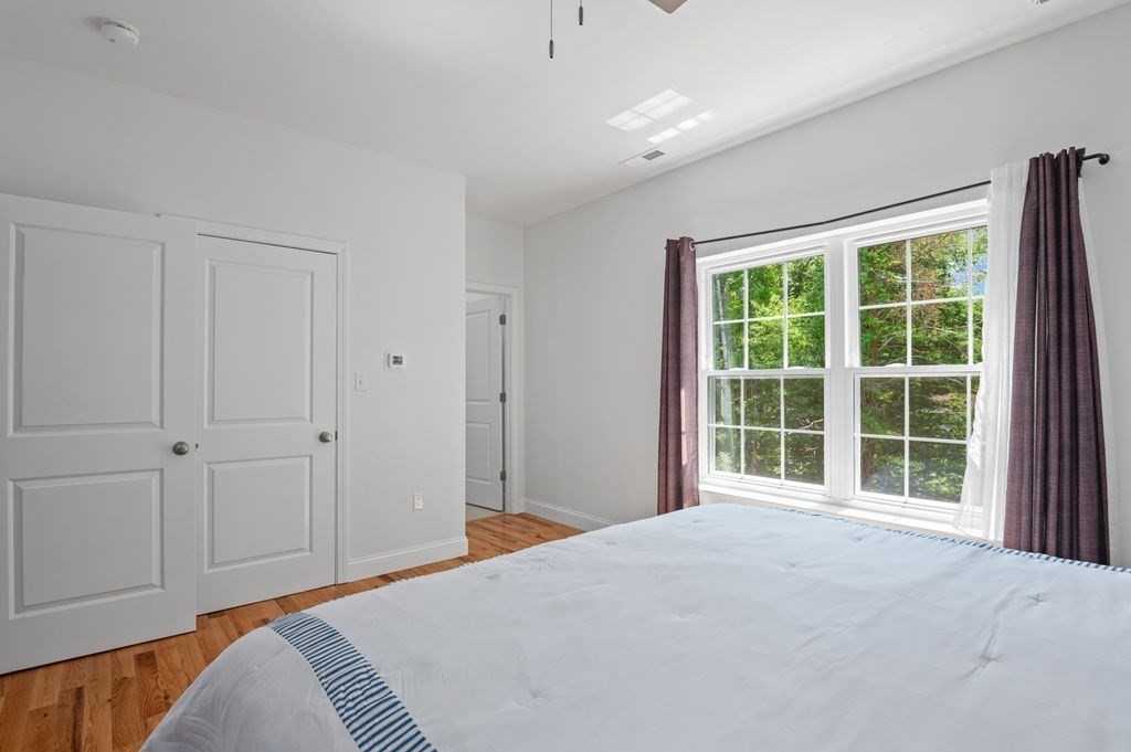196 Main Street, Unit 196 Groveland, MA 01834 - Photo 14 of 35 a bedroom with a bed and a window
