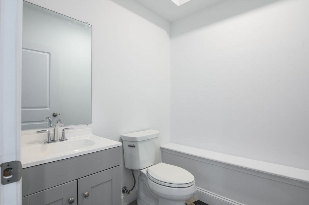 196 Main Street, Unit 196 Groveland, MA 01834 - Photo 25 of 35 a bathroom with a sink a toilet and a mirror