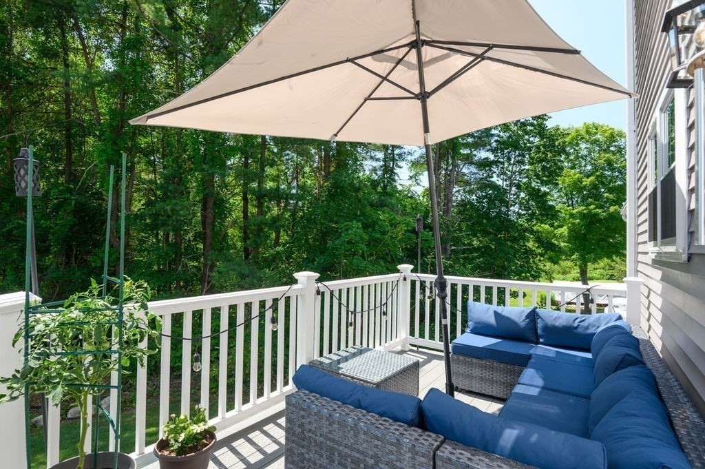 196 Main Street, Unit 196 Groveland, MA 01834 - Photo 26 of 35 a view of a patio with a table and chairs under an umbrella