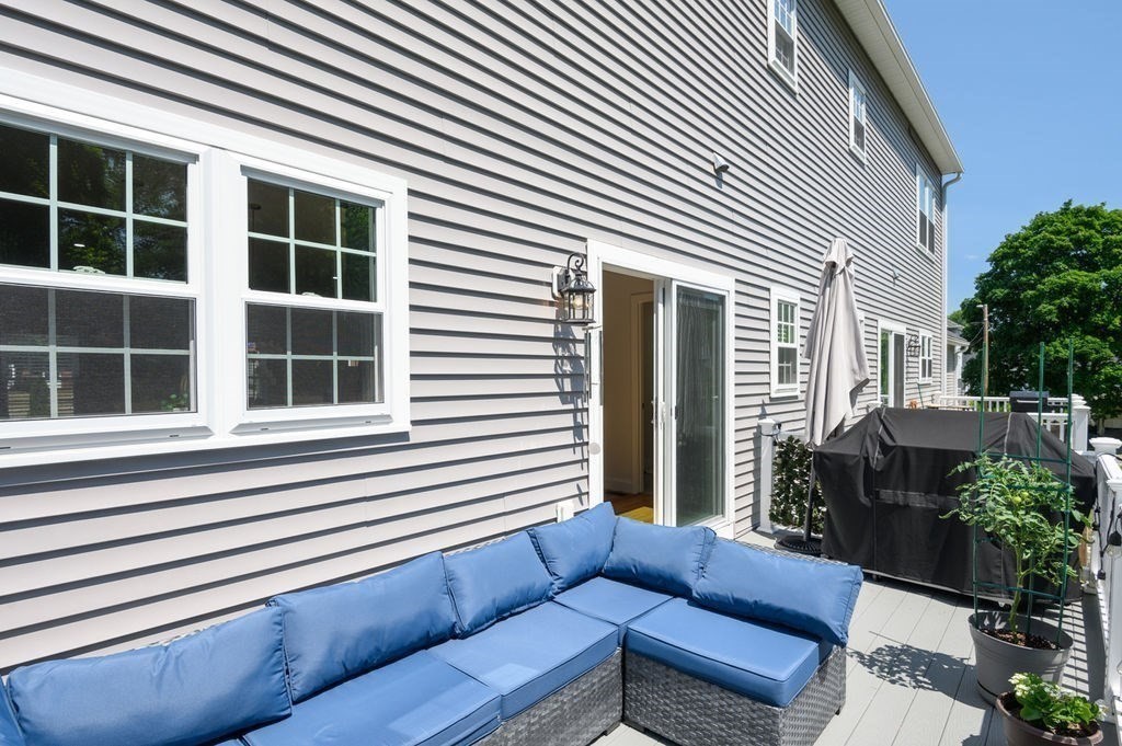 196 Main Street, Unit 196 Groveland, MA 01834 - Photo 28 of 35 a view of a house and a couches in the patio