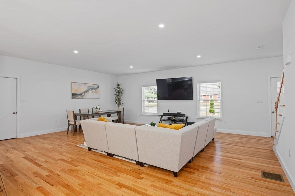 196 Main Street, Unit 196 Groveland, MA 01834 - Photo 8 of 35 a living room with furniture and a flat screen tv