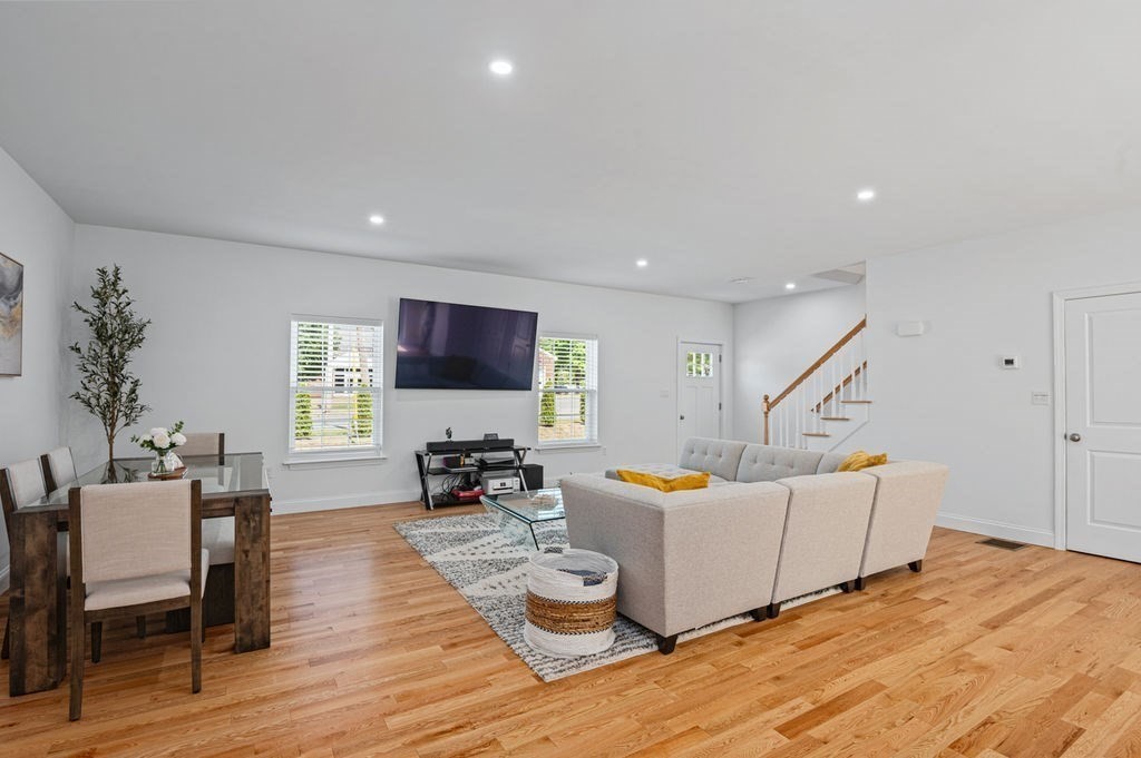 196 Main Street, Unit 196 Groveland, MA 01834 - Photo 9 of 35 a living room with furniture and wooden floor
