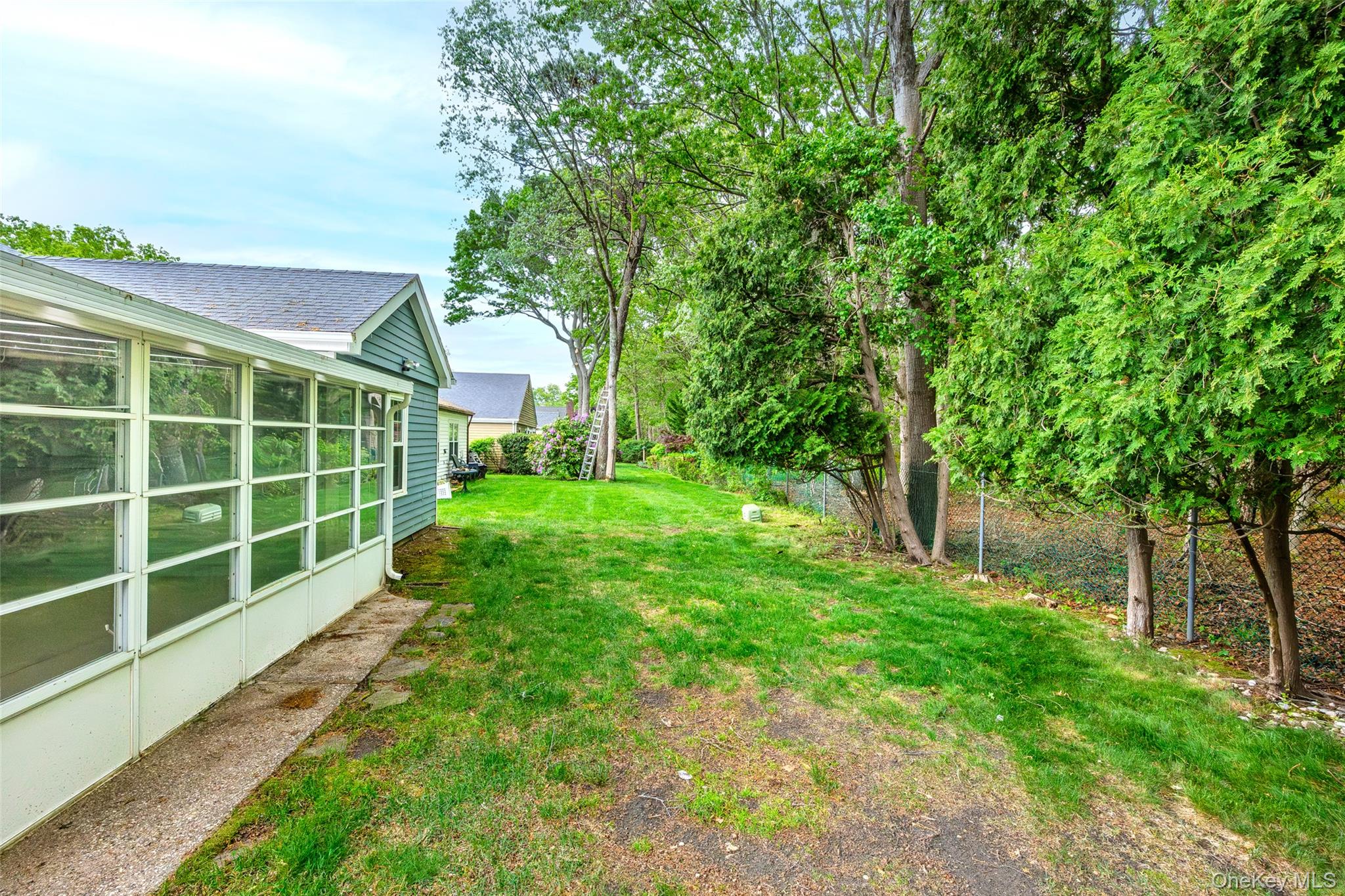 220 Belfast Lane Ridge, NY 11961 - Photo 4 of 44 a view of a house with a yard and large trees