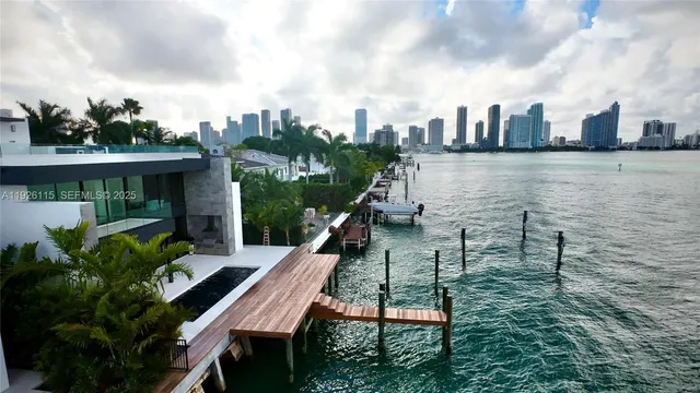 a view of a roof deck with table and chairs a barbeque with wooden fence