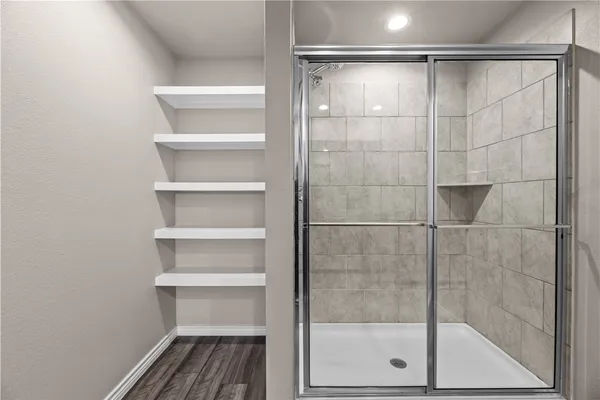 a bathroom with a glass shower door