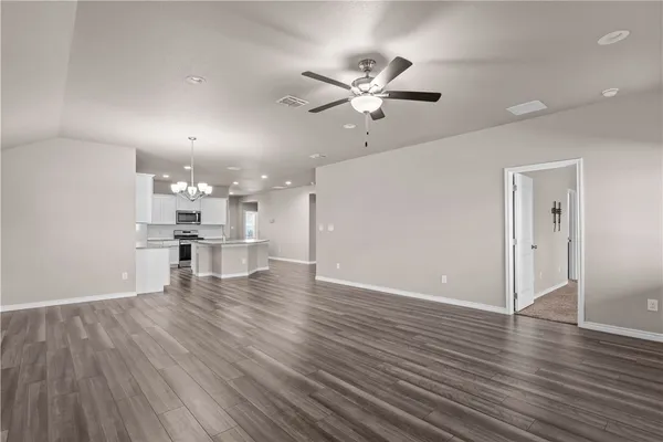 a view of a kitchen with a sink and wooden floor