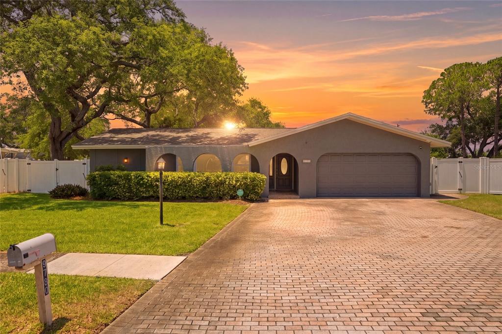 9760 136th Street Seminole, FL 33776 - Photo 1 of 41 a front view of a house with a yard and garage