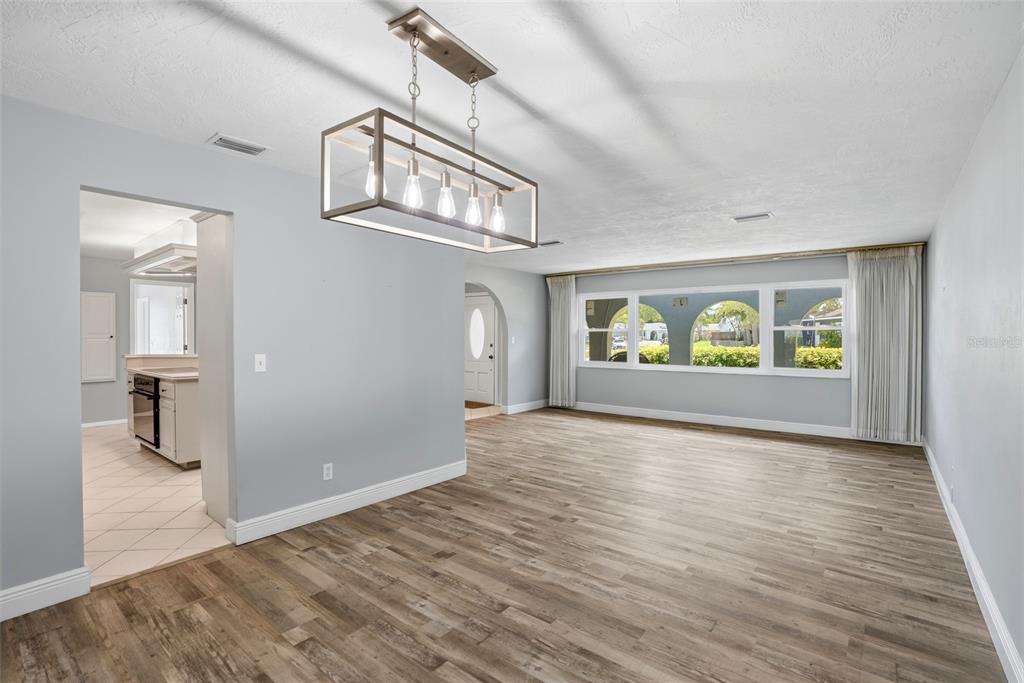 9760 136th Street Seminole, FL 33776 - Photo 12 of 41 wooden floor in an empty room with a window