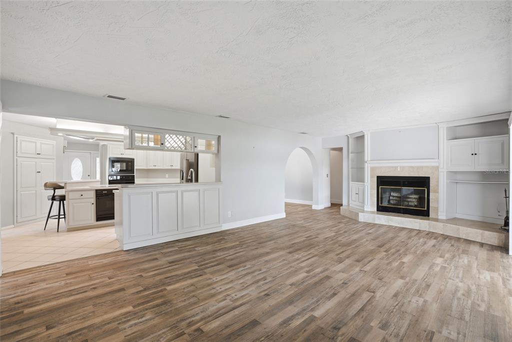 9760 136th Street Seminole, FL 33776 - Photo 13 of 41 a view of a kitchen with furniture and a fireplace