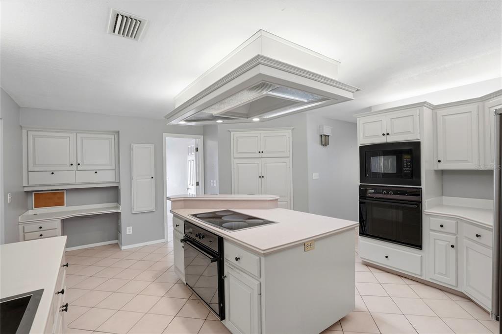 9760 136th Street Seminole, FL 33776 - Photo 16 of 41 a kitchen that has a stove and a refrigerator
