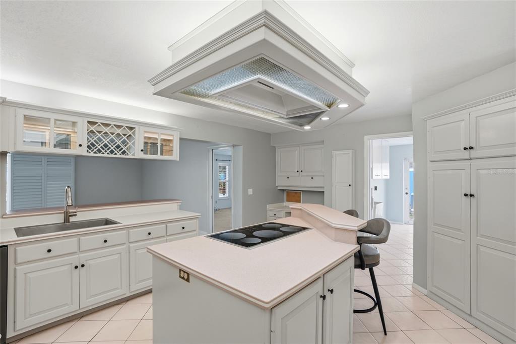 9760 136th Street Seminole, FL 33776 - Photo 17 of 41 a kitchen with a sink cabinets and wooden floor