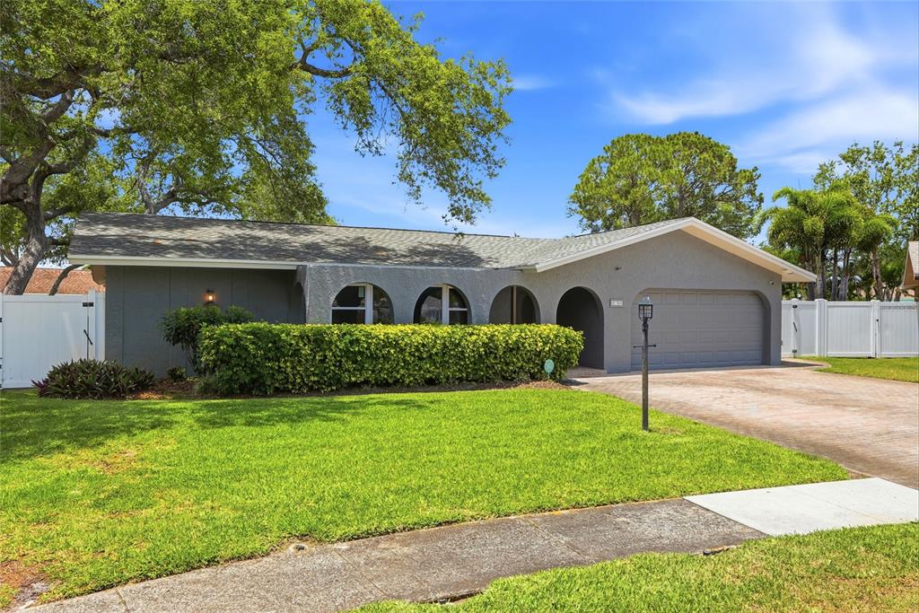 9760 136th Street Seminole, FL 33776 - Photo 2 of 41 a front view of house with yard and green space