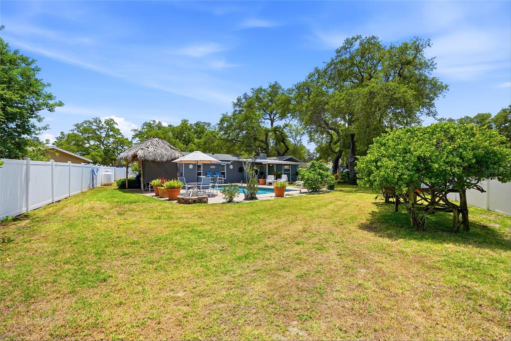 9760 136th Street Seminole, FL 33776 - Photo 35 of 41 a swimming pool with wooden fence