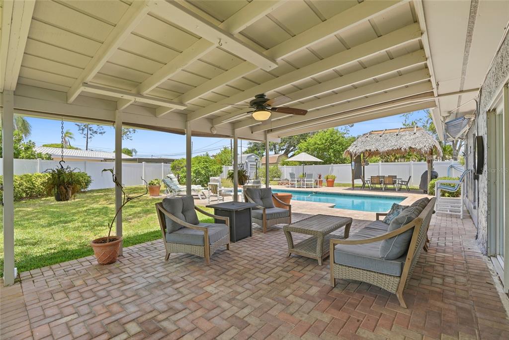 9760 136th Street Seminole, FL 33776 - Photo 6 of 41 a roof deck with table and chairs and potted plants