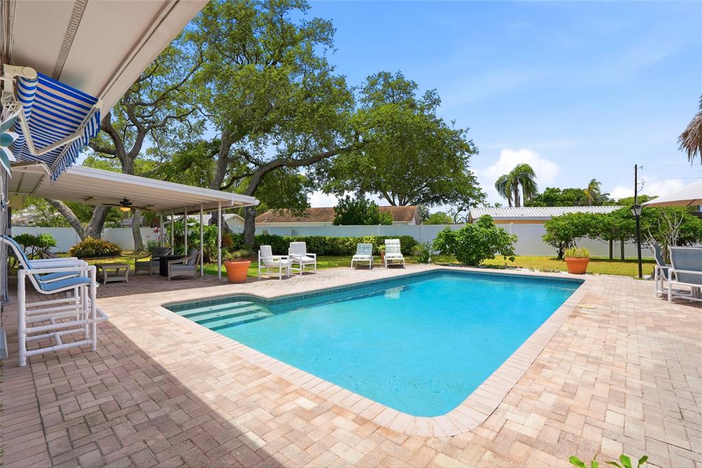 9760 136th Street Seminole, FL 33776 - Photo 7 of 41 a view of swimming pool with sitting area and furniture
