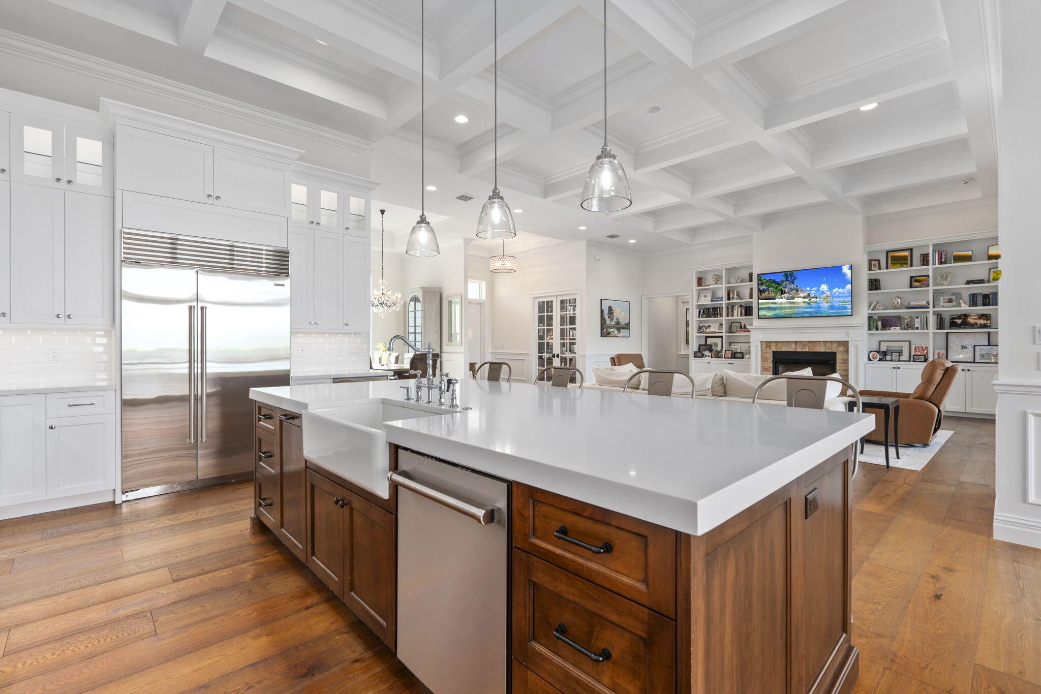 54 South Sewalls Point Road Sewall's Point, FL 34996 - Photo 16 of 68 a large kitchen with kitchen island a sink a stove a dining table and chairs with wooden floor