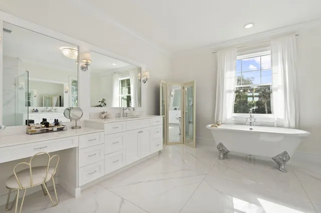 a bathroom with a toilet a sink a mirror and vanity