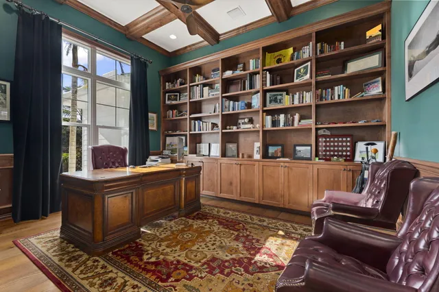 a spacious bedroom with a bed and a chandelier