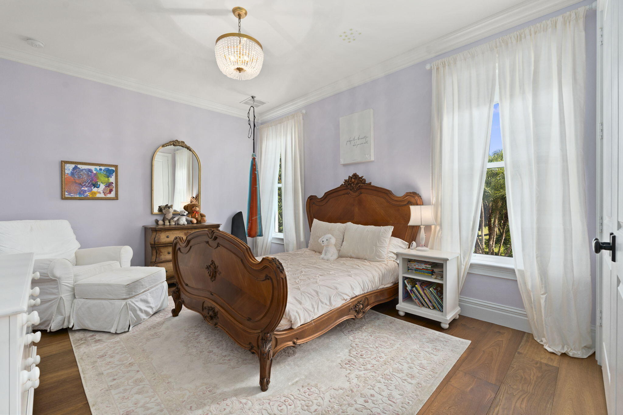 54 South Sewalls Point Road Sewall's Point, FL 34996 - Photo 32 of 68 a spacious bedroom with a bed and a chandelier