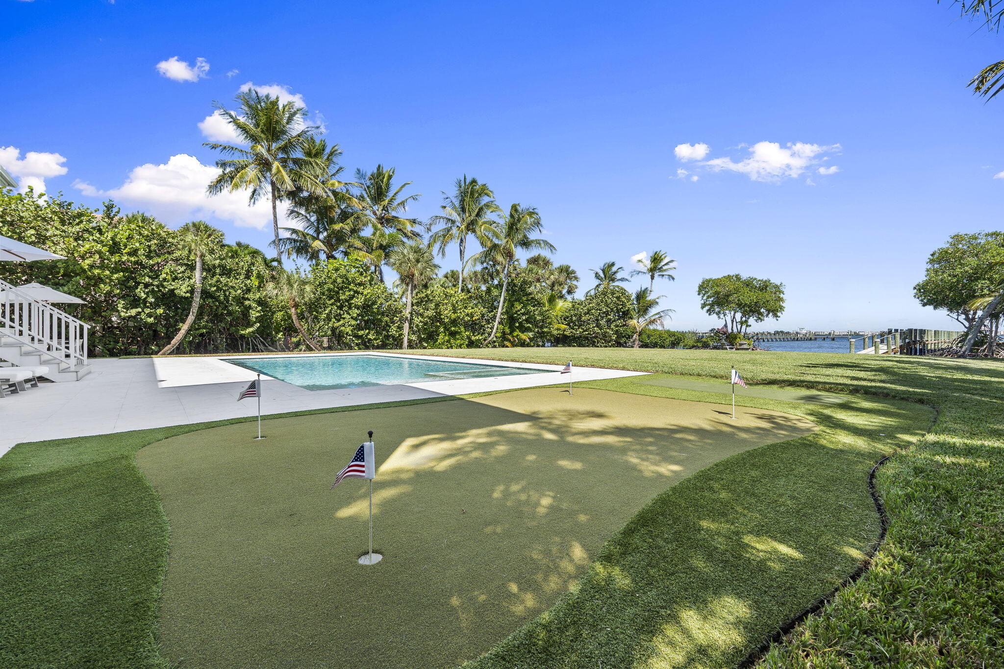 54 South Sewalls Point Road Sewall's Point, FL 34996 - Photo 42 of 68 a view of a swimming pool with an outdoor space and seating area