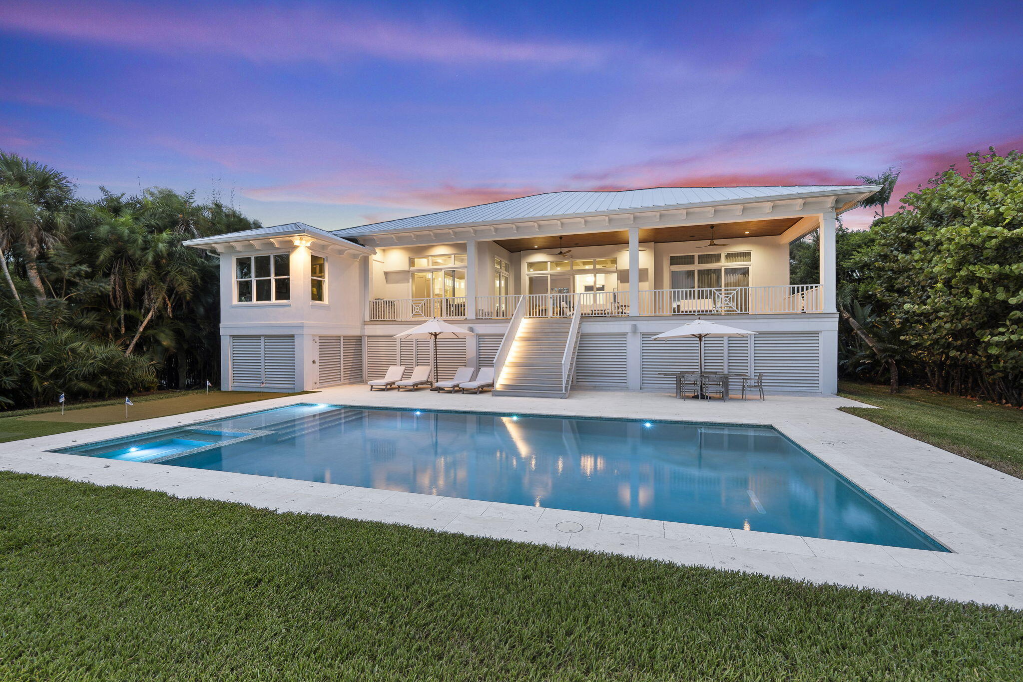 54 South Sewalls Point Road Sewall's Point, FL 34996 - Photo 60 of 68 a view of a house with a swimming pool with a yard