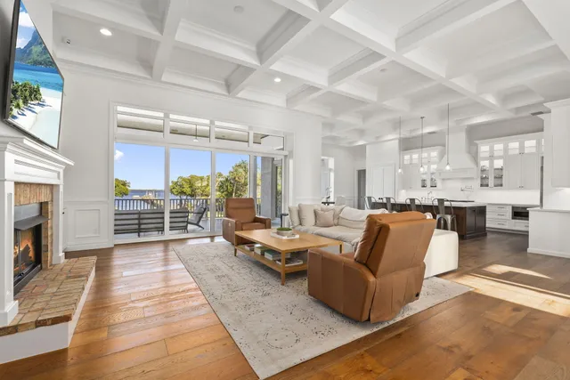 a living room with furniture a fireplace and a table