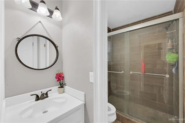a bathroom with a sink mirror and toilet