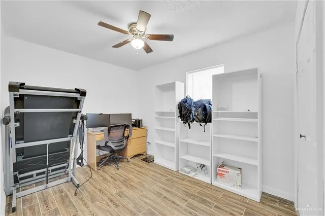 a view of workspace with wooden floor shelves