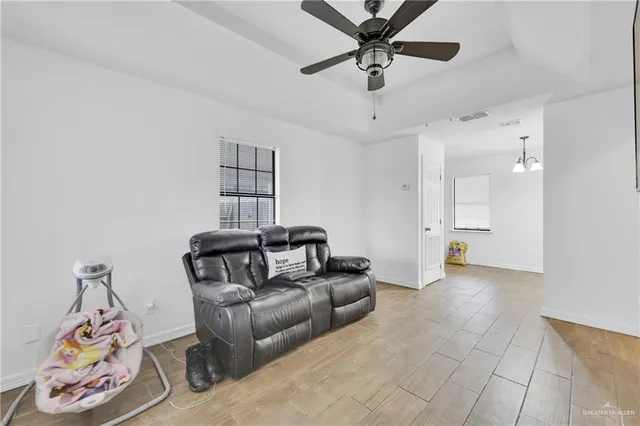 a view of a livingroom with furniture and a ceiling fan