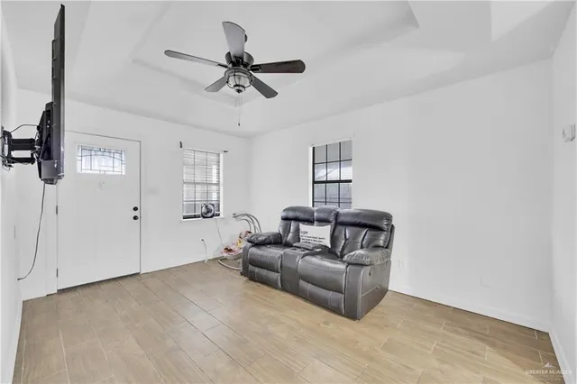 a living room with furniture and a ceiling fan