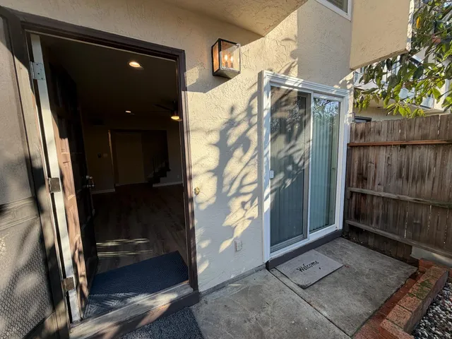 a view of a house with a door and wooden walls