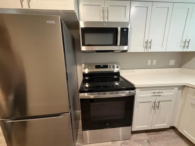 a stove top oven sitting inside of a kitchen