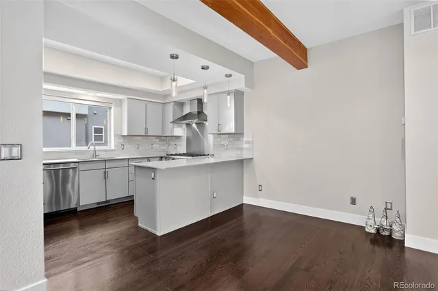 a kitchen with kitchen island granite countertop a sink cabinets and stainless steel appliances