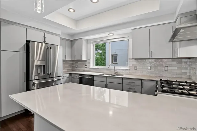a kitchen with a stove and white cabinets